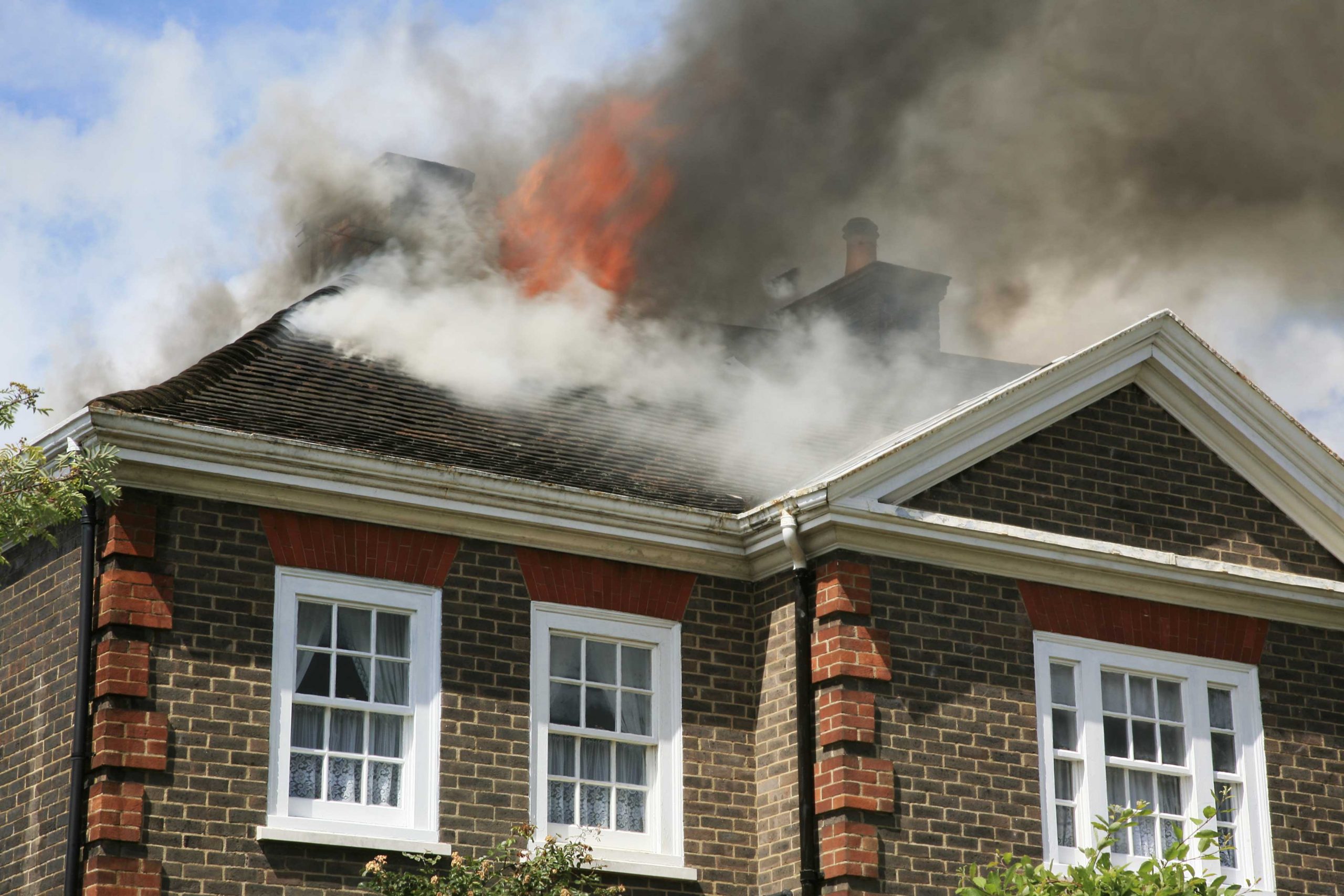 House on fire with fire and smoke damage